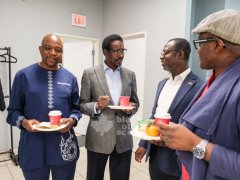 4.-Community-leaders-including-ACAO-Board-Chair-Serge-Banyongen-left-and-Chief-Servant-Officer-Hector-Addison-second-from-right-chat-during-the-launch-of-the-new-walk-in-clinic