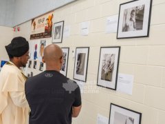 4.-An-exhibiting-artist-from-the-Cultivating-Legacy-program-engages-with-an-attendee-viewing-the-exhibition