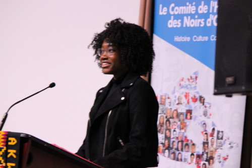 Maya Basudde reads her poem at the Black History Month launch